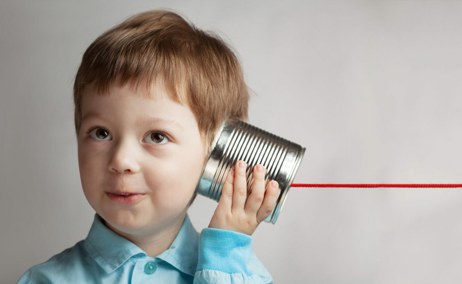 happy boy play in the tin can phone